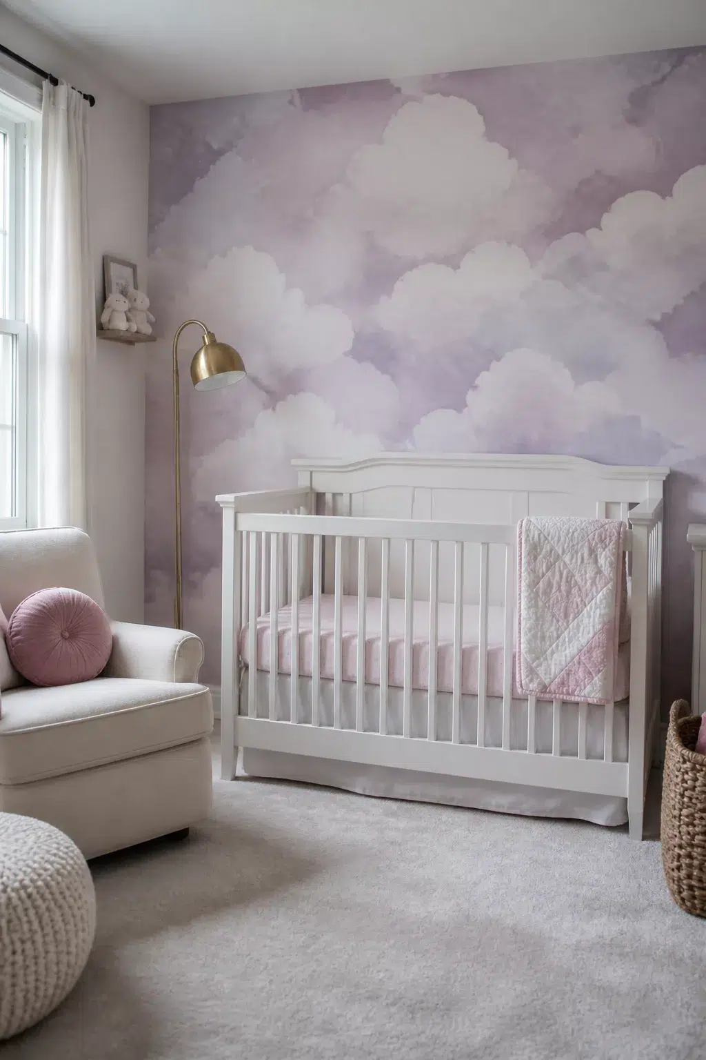 Baby girl nursery ideas with clouds — lilac watercolor cloud wallpaper with white crib and brass lamp