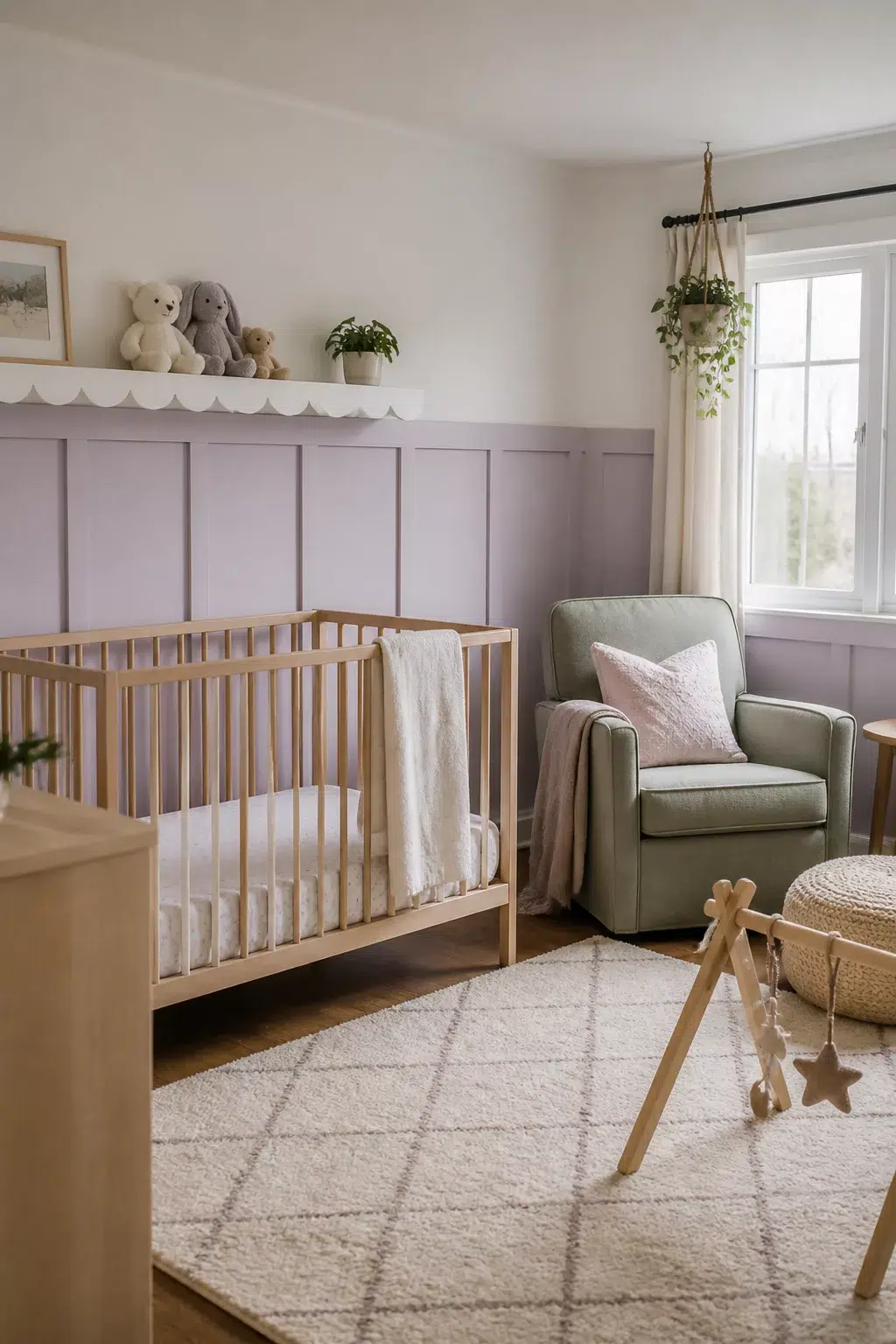 Pale lavender board and batten nursery walls with scallop shelf, wood crib, and sage glider.