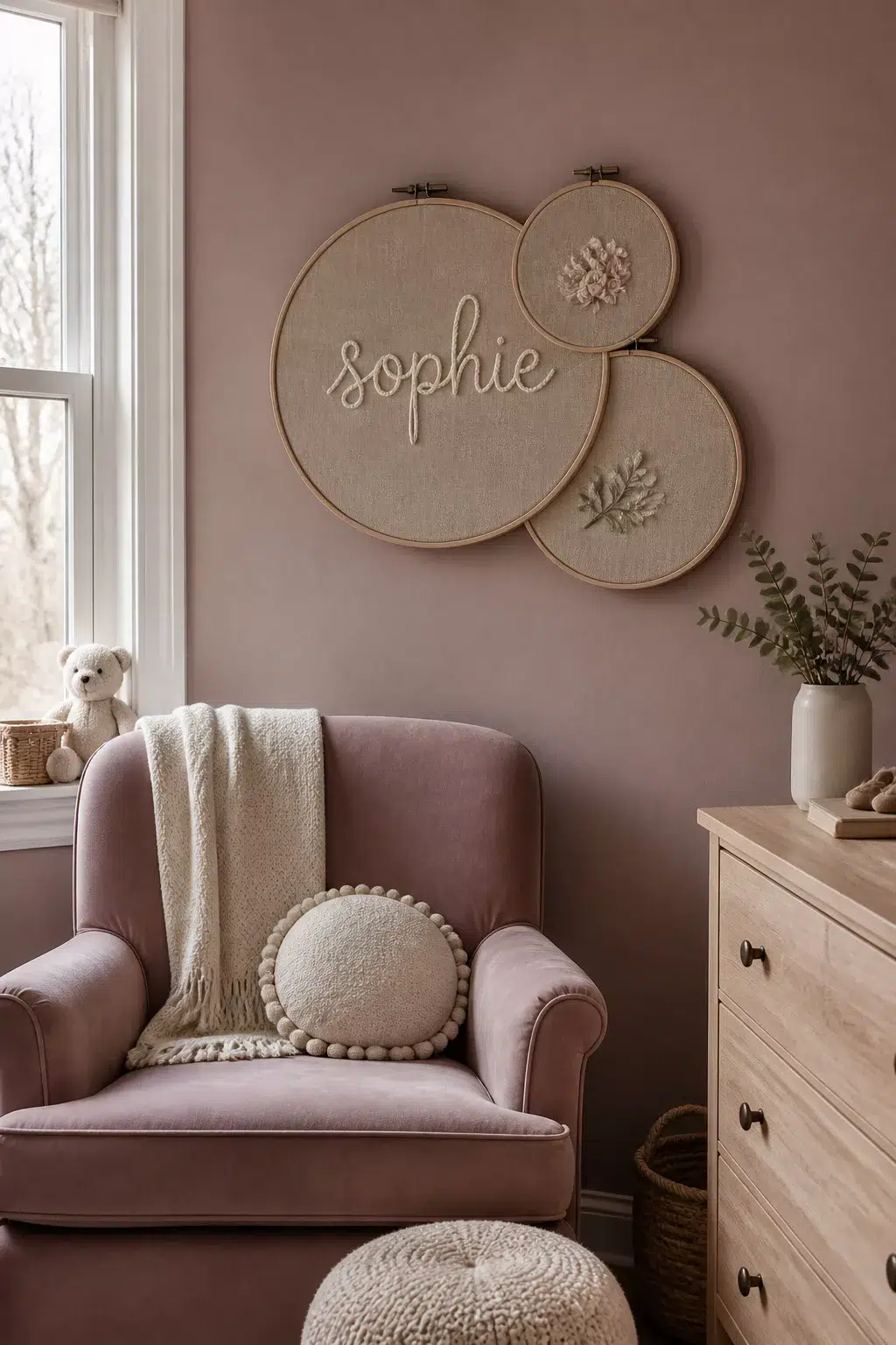 Blush nursery with embroidery hoop nursery name signs spelling Sophie above a pink velvet glider.