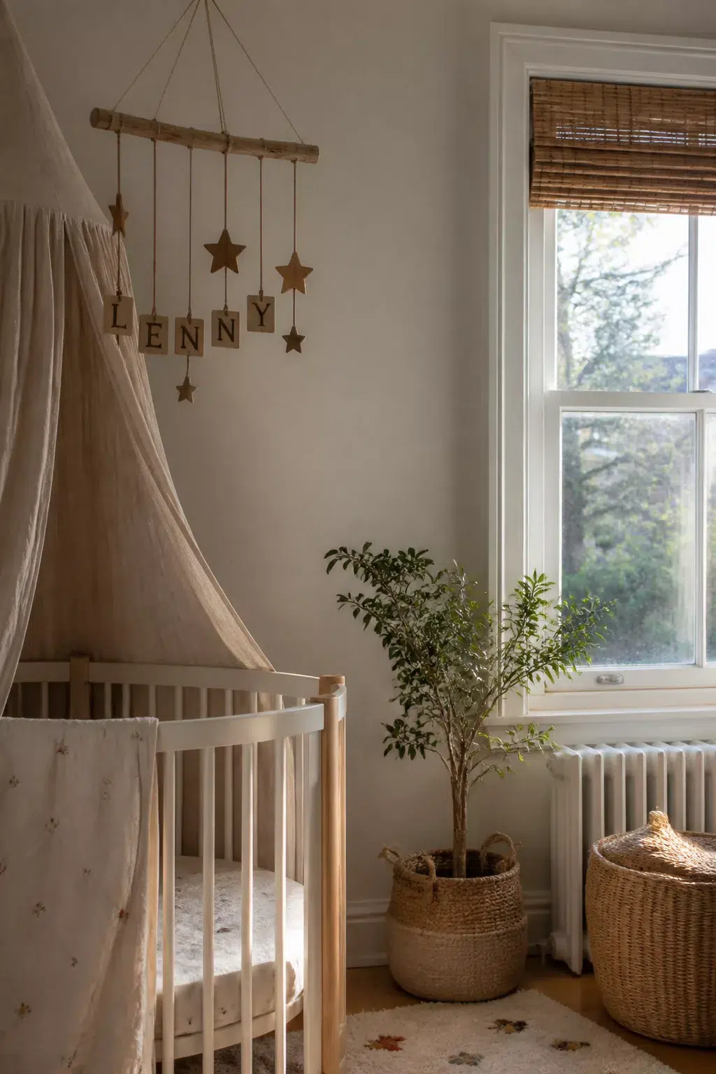 Wooden star mobile nursery name sign spelling LENNY above a natural birch crib — nursery name signs idea