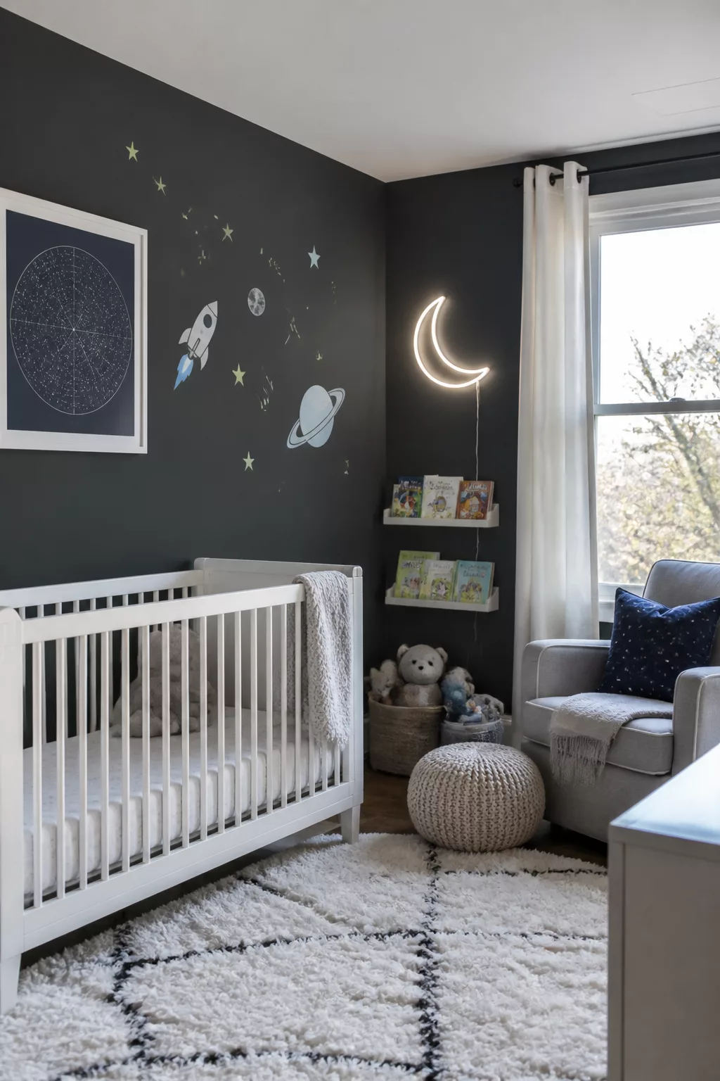 Space themed nursery ideas with charcoal walls, crescent moon neon light, white crib, and space wall decals