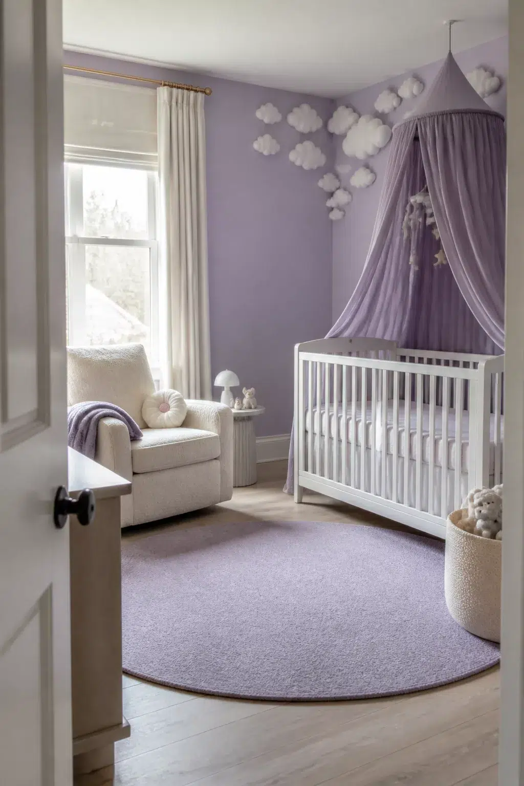 Whimsical baby girl nursery with lilac walls, draped purple crib canopy, cloud wall decor, and cream glider