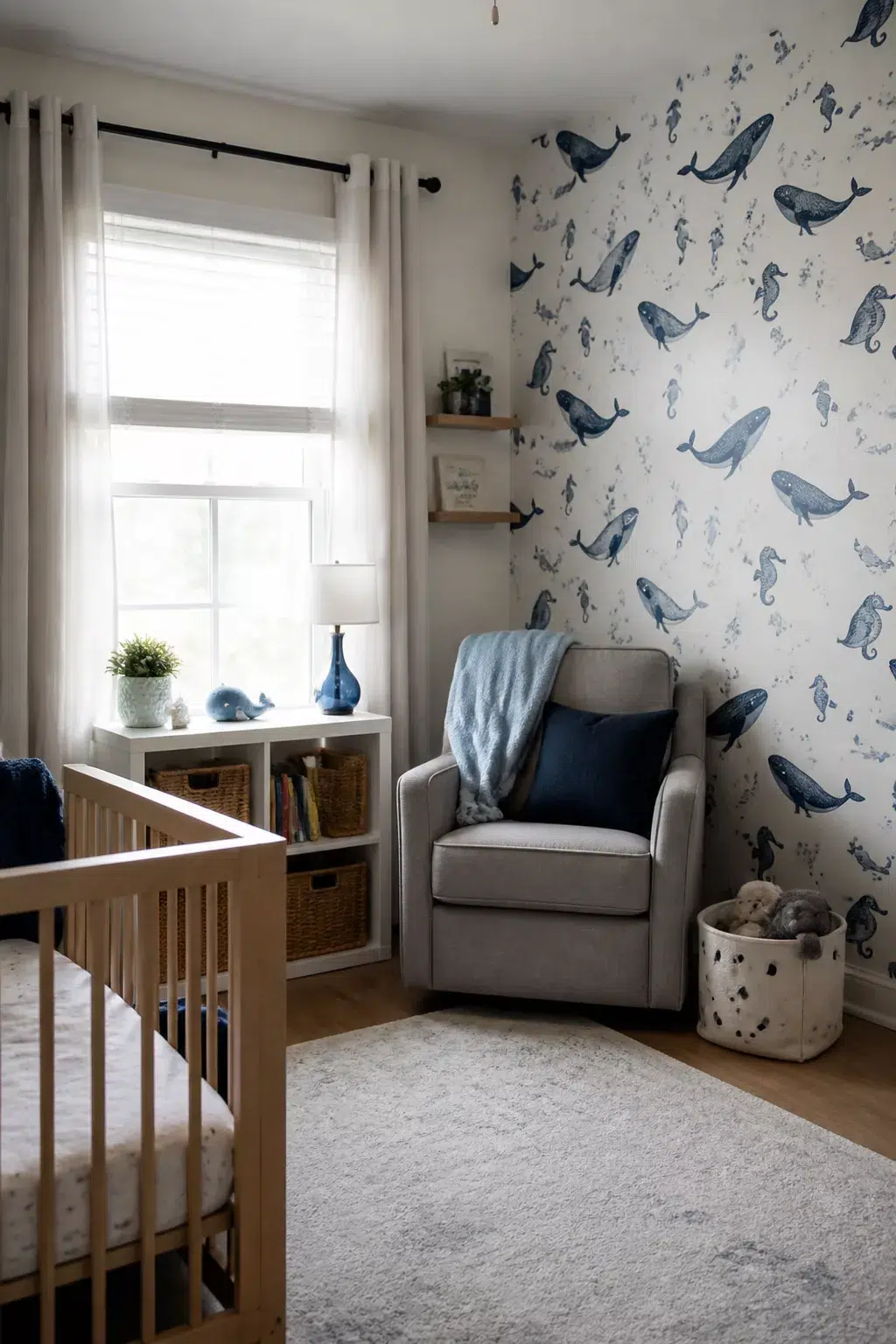 Blue whale and seahorse peel-and-stick wallpaper accent wall in an under the sea nursery ideas roundup
